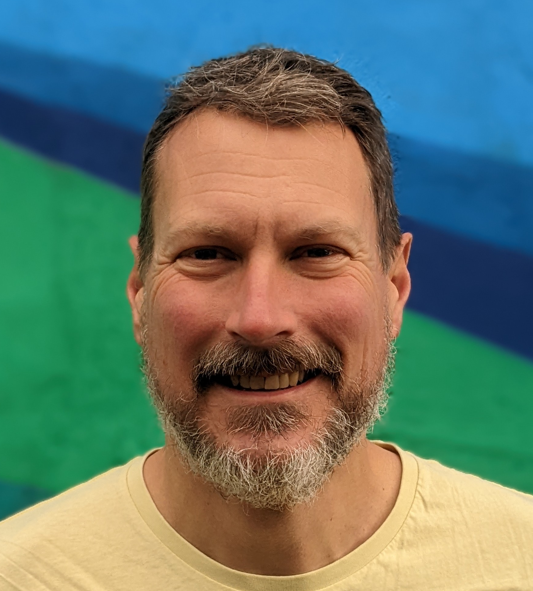 peteheadshot-bluegreenyellow Pete Baikins Headshot Photo